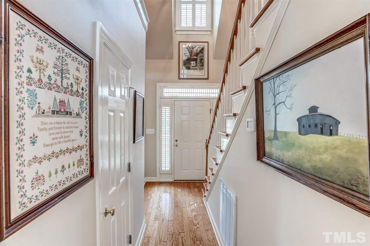 1004 Tyler Farms Drive Raleigh, NC 27603 - Photo 7 of 29 a view of a hallway with wooden floor and entryway