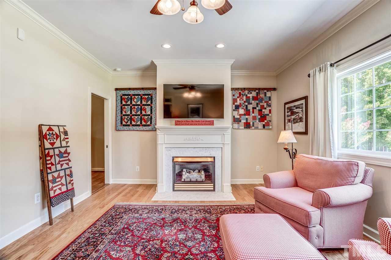1004 Tyler Farms Drive Raleigh, NC 27603 - Photo 9 of 29 a living room with furniture and a fireplace