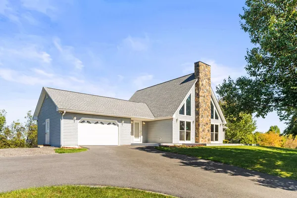 a view of a house with a yard and garage