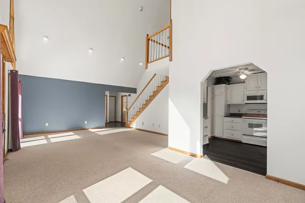 a kitchen with white cabinets and white appliances