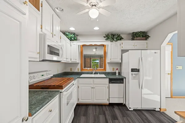 a kitchen with a stove and a white cabinet