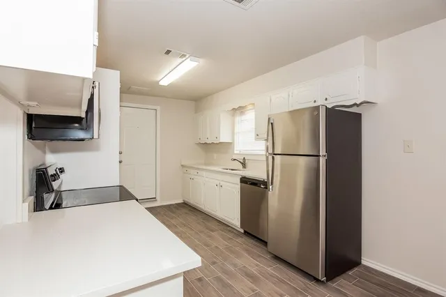 a kitchen with a refrigerator and a sink