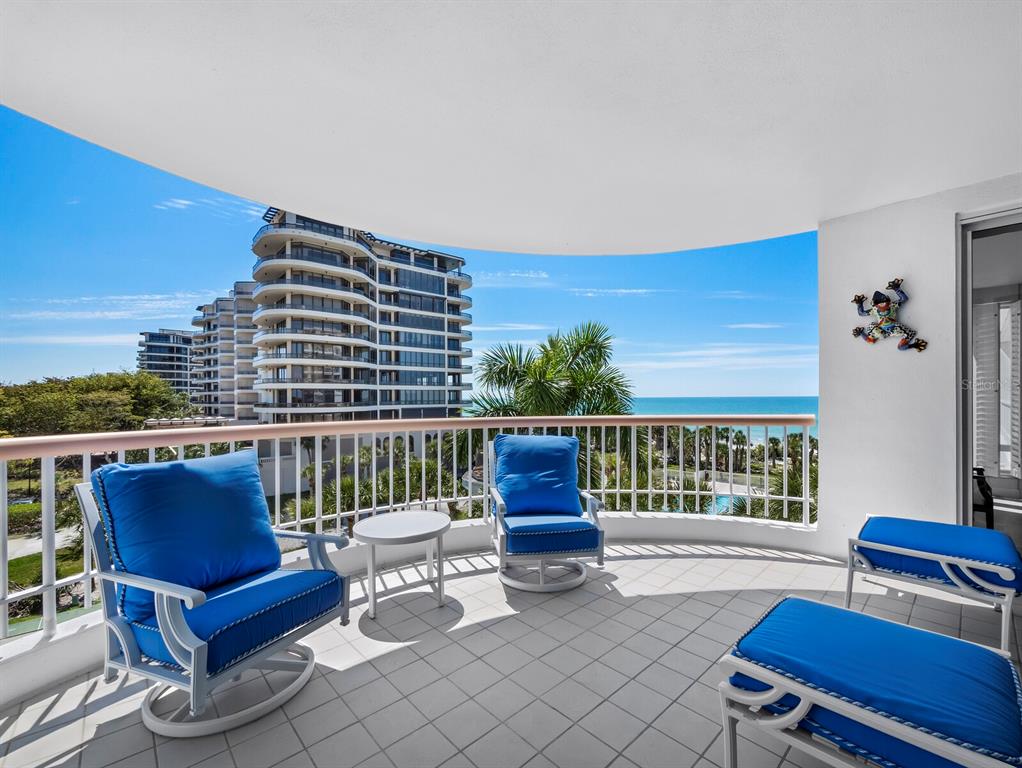 455 Longboat Club Road, Unit 402 Longboat Key, FL 34228 - Photo 8 of 48 a roof deck with a table and chairs