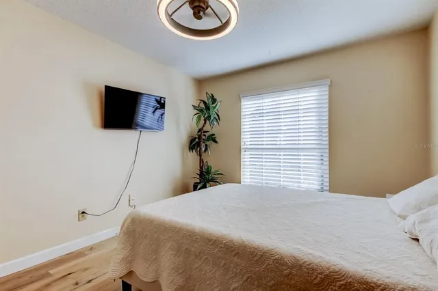 a bedroom with a bed and a flat screen tv