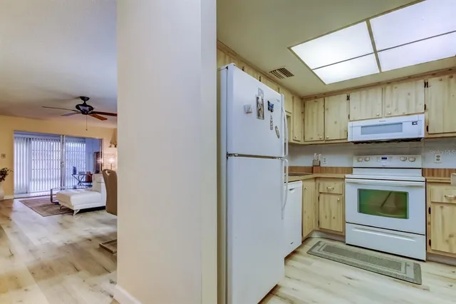 a kitchen with refrigerator and cabinets