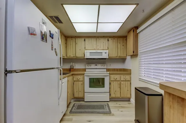 a kitchen with stainless steel appliances a refrigerator and a stove