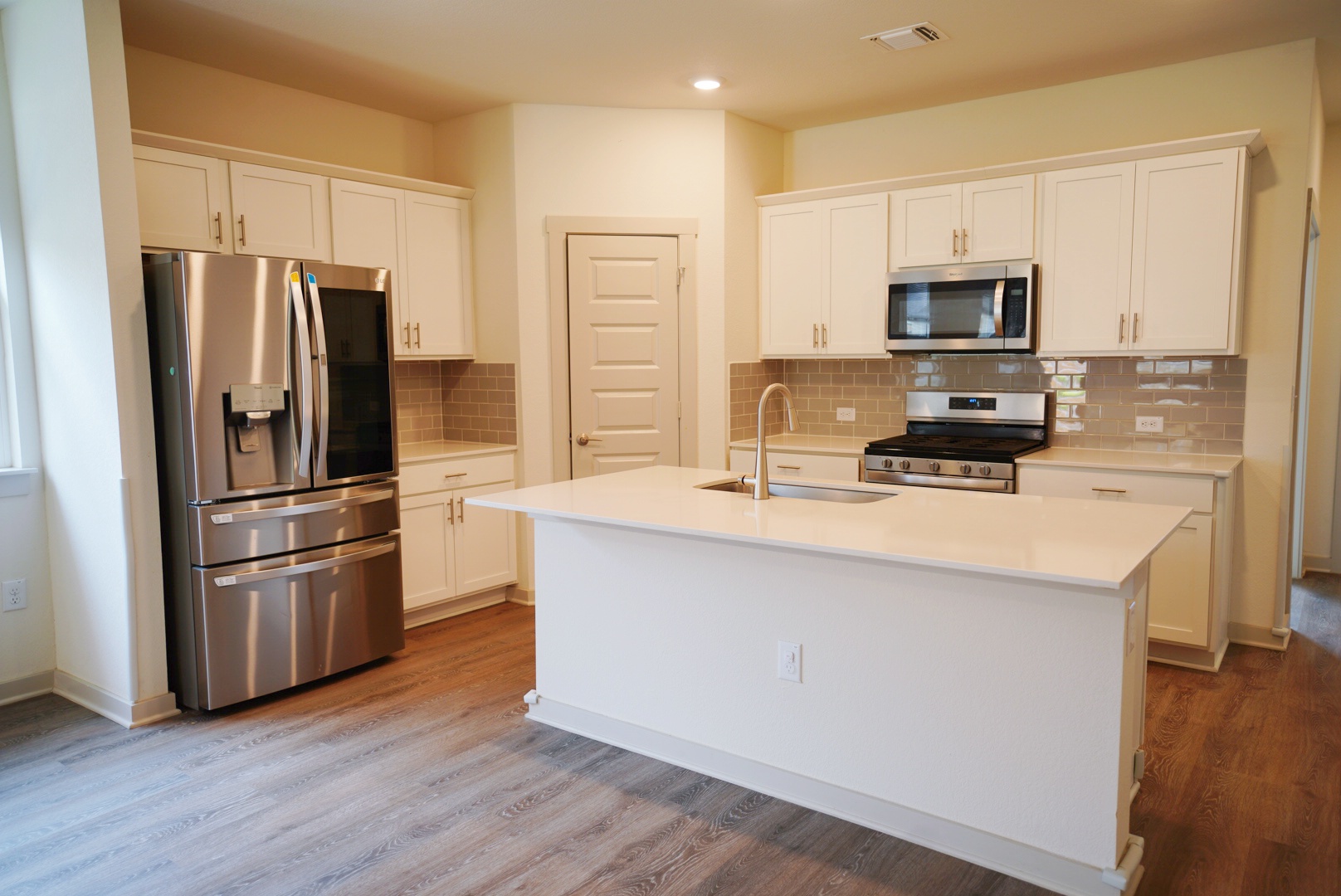 10601 Gonzales Ranger Pass Austin, TX 78754 - Photo 4 of 17 a kitchen with stainless steel appliances a refrigerator sink and microwave