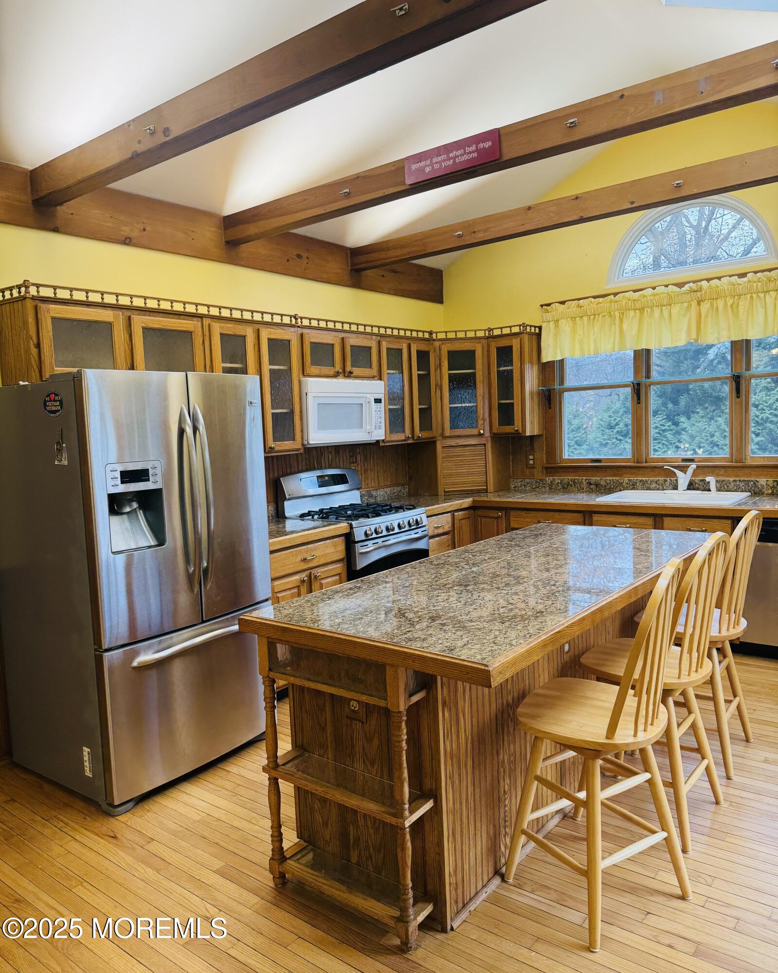 8 Ivy Lane Wrightstown, NJ 08562 - Photo 48 of 106 a kitchen with stainless steel appliances granite countertop a table chairs and a refrigerator