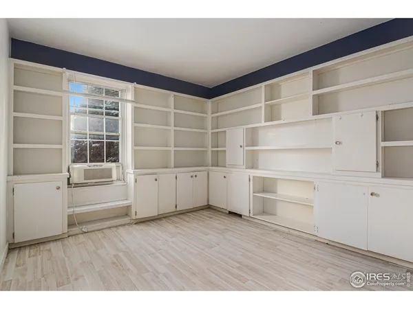a bedroom with a bed window and a night stand