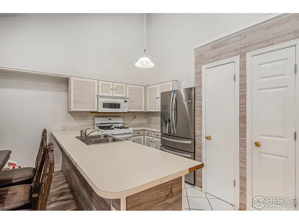 a kitchen with kitchen island a sink appliances and cabinets