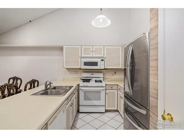 a kitchen with stainless steel appliances a refrigerator sink and stove