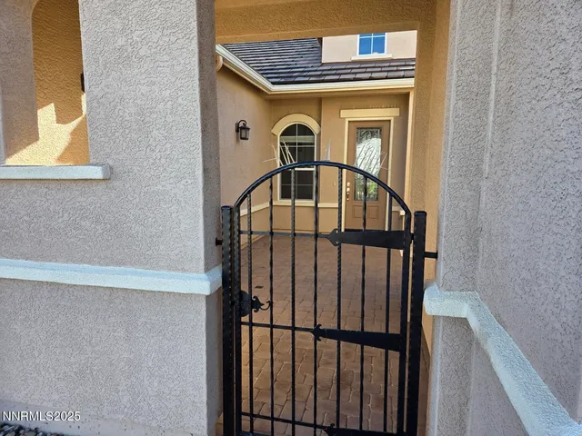 a view of an empty room with wooden floor and windows