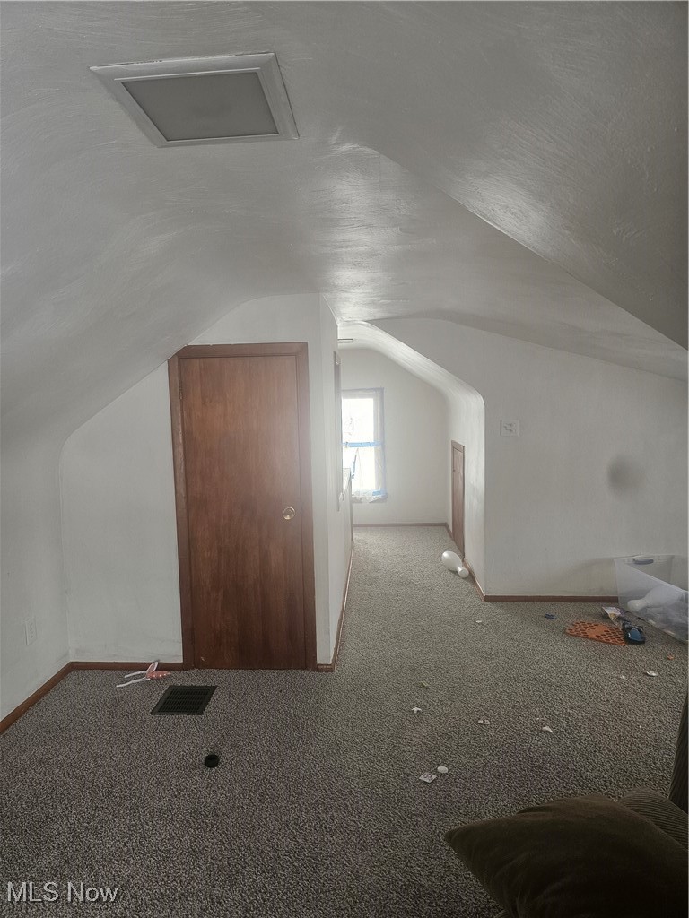 25150 Columbus Road Bedford Heights, OH 44146 - Photo 24 of 30 Bonus room featuring carpet flooring and vaulted ceiling