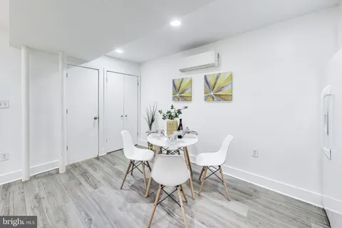 a dining room with furniture and wooden floor