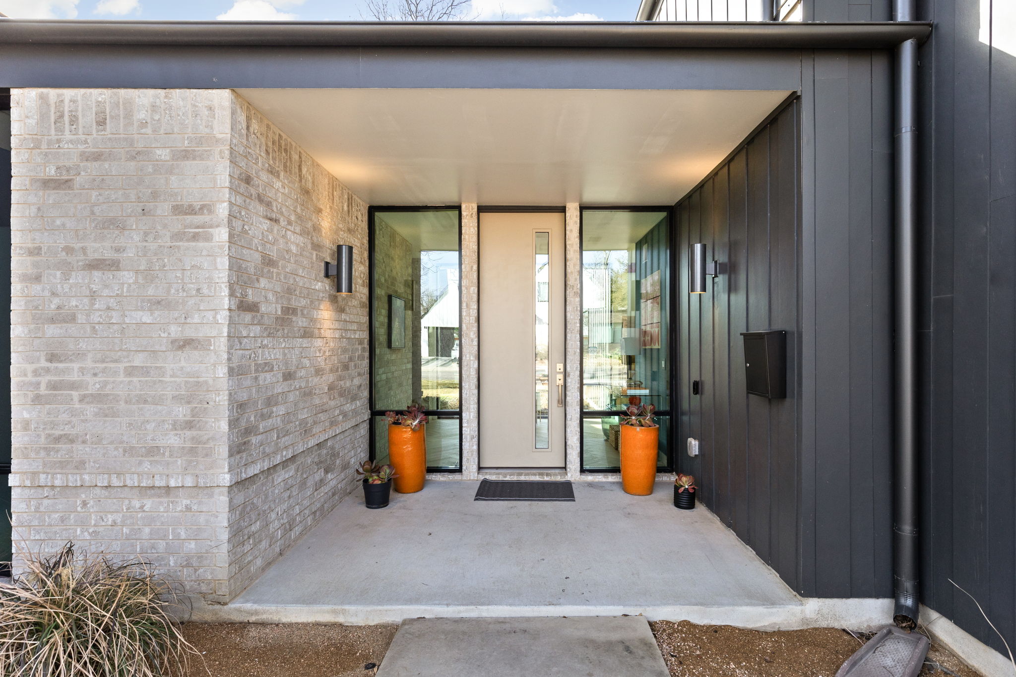 7502 St Louis Street Austin, TX 78757 - Photo 3 of 38 Entrance to property with brick siding and board and batten siding