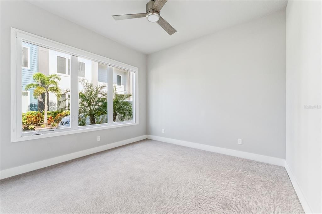 7760 Sandy Ridge Drive, Unit 112 Reunion, FL 34747 - Photo 11 of 23 an empty room with a window and a ceiling fan