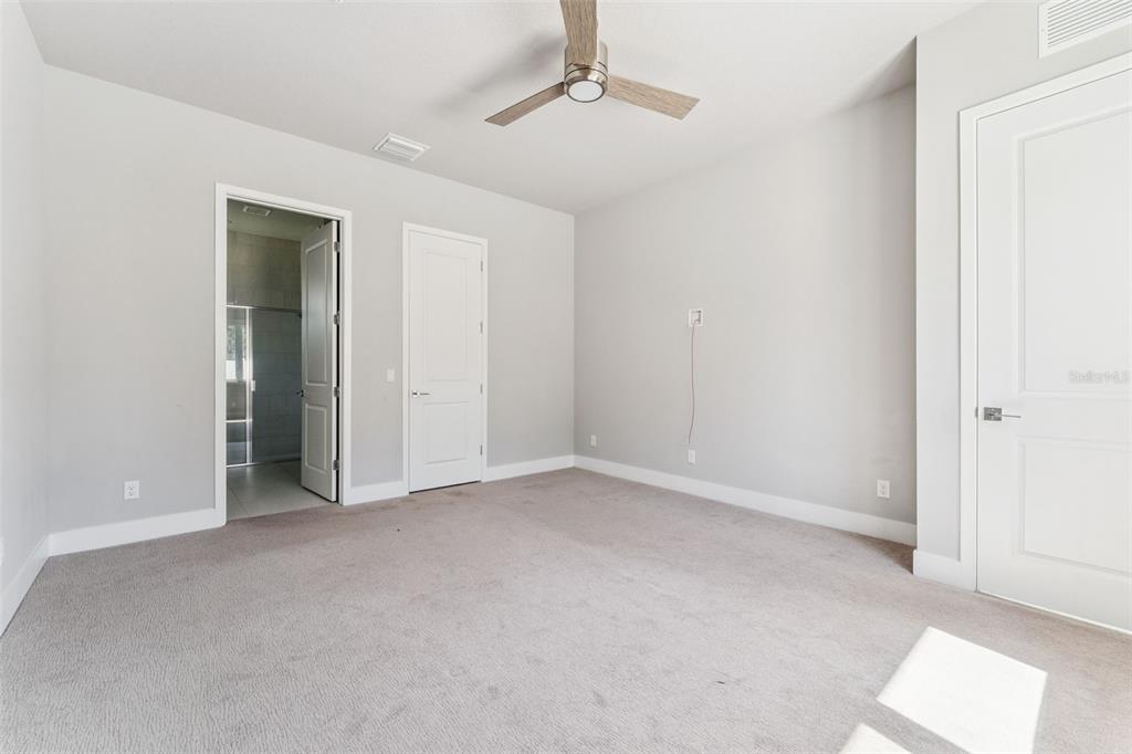 7760 Sandy Ridge Drive, Unit 112 Reunion, FL 34747 - Photo 13 of 23 an empty room with windows and cabinet