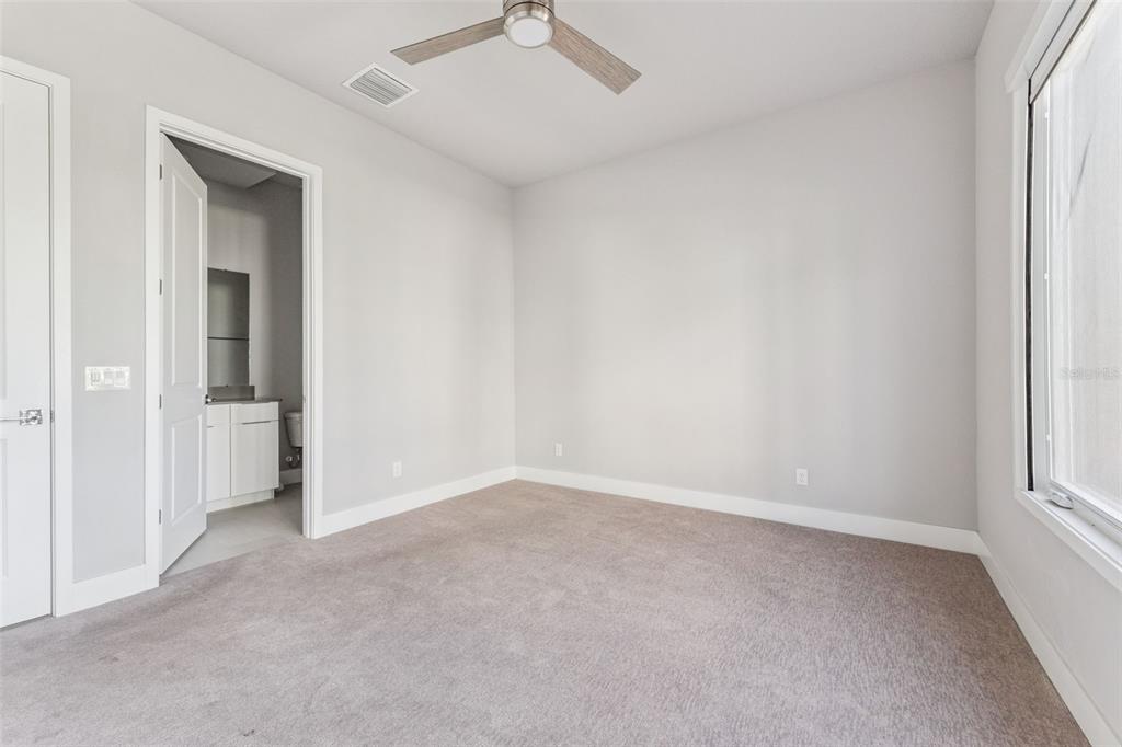 7760 Sandy Ridge Drive, Unit 112 Reunion, FL 34747 - Photo 14 of 23 an empty room with a empty space and a ceiling fan