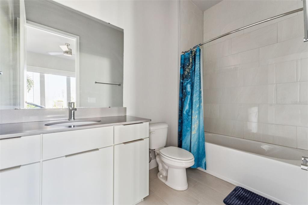 7760 Sandy Ridge Drive, Unit 112 Reunion, FL 34747 - Photo 17 of 23 a bathroom with a sink a toilet and shower