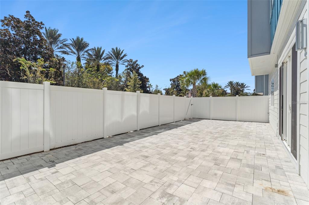 7760 Sandy Ridge Drive, Unit 112 Reunion, FL 34747 - Photo 18 of 23 a view of backyard with potted plants and wooden fence