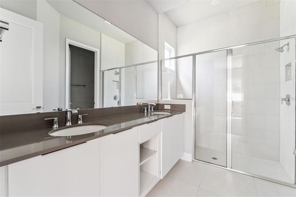 7760 Sandy Ridge Drive, Unit 112 Reunion, FL 34747 - Photo 21 of 23 a bathroom with a granite countertop sink and a mirror
