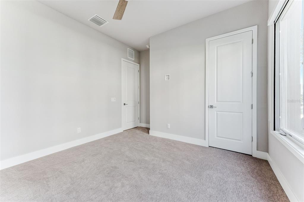 7760 Sandy Ridge Drive, Unit 112 Reunion, FL 34747 - Photo 9 of 23 an empty room with windows