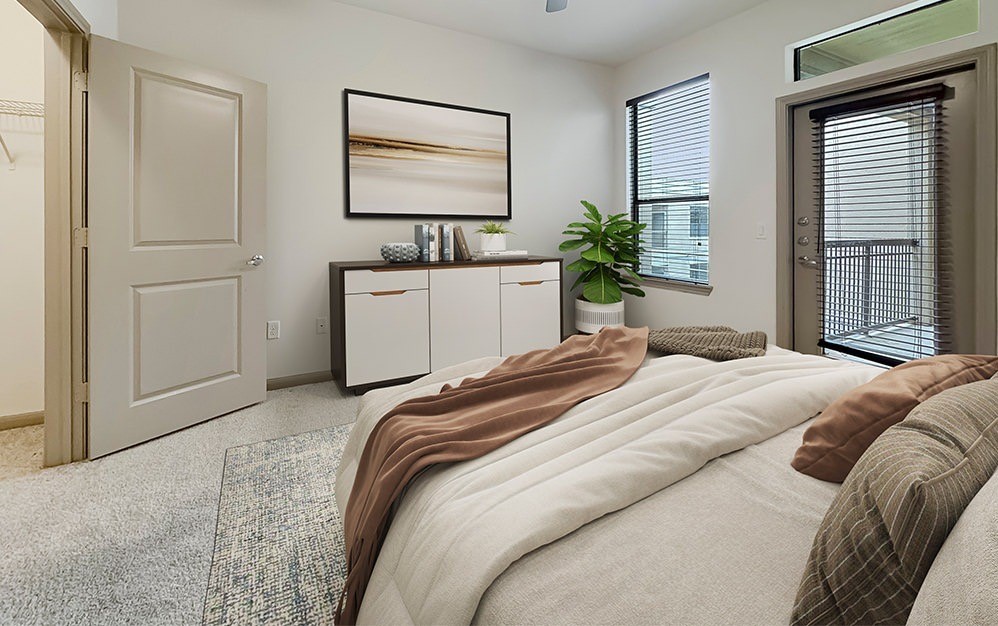 2700 Brazos Street, Unit 4424 Houston, TX 77006 - Photo 3 of 24 a bedroom with a bed and a potted plant