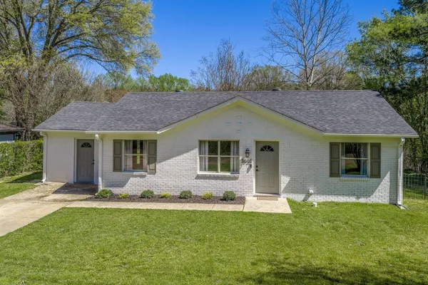 a front view of house with yard and green space
