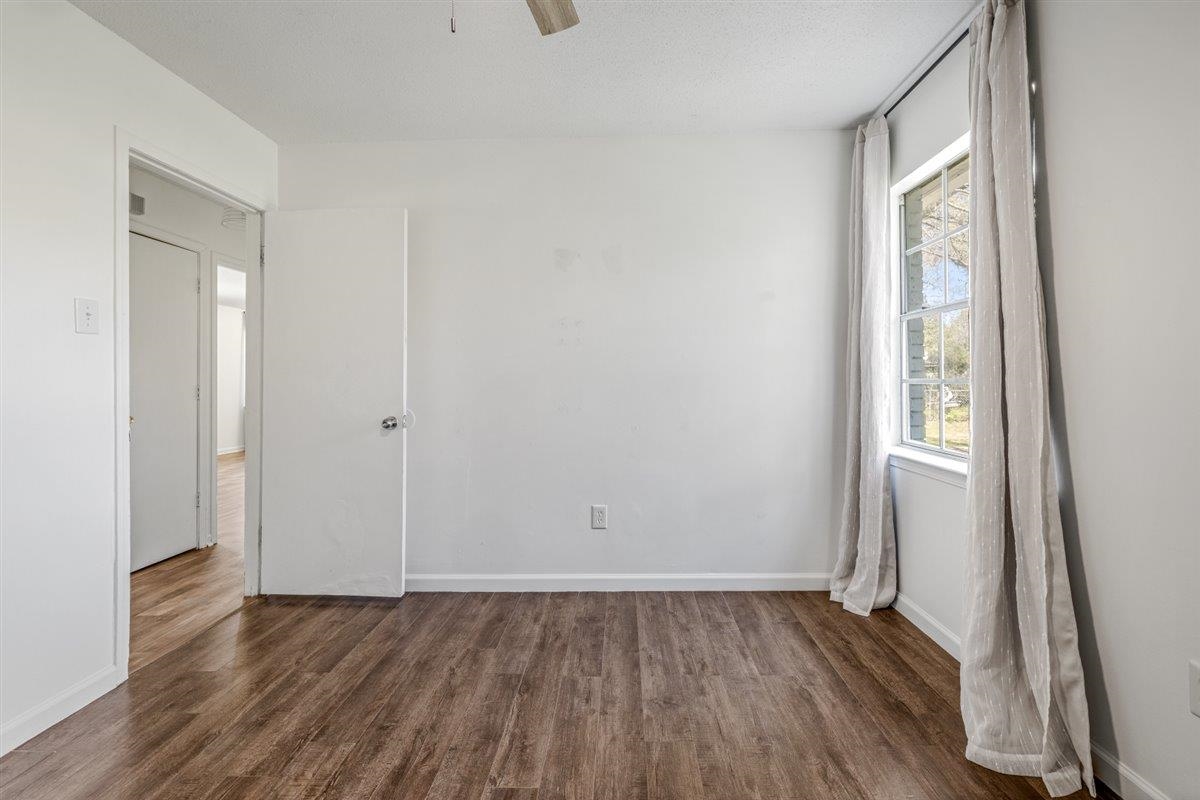 5626 Lamb Road Arlington, TN 38002 - Photo 23 of 33 a view of an empty room with wooden floor and a window
