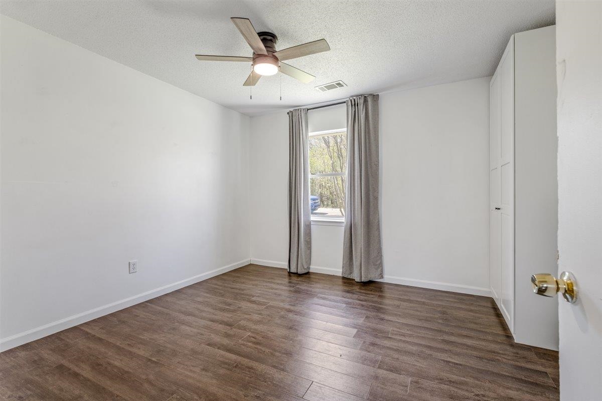 5626 Lamb Road Arlington, TN 38002 - Photo 24 of 33 an empty room with wooden floor and ceiling fan