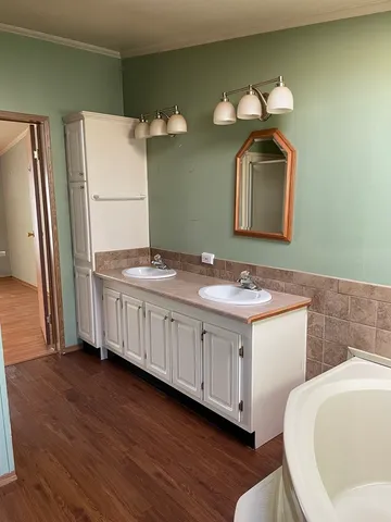 a bathroom with a double vanity sink and a mirror