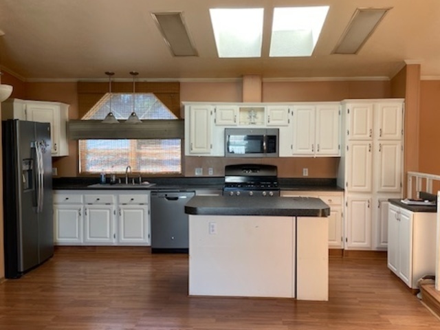 895 Cherry Street Manteno, IL 60950 - Photo 3 of 38 a kitchen with stainless steel appliances a stove a sink and a refrigerator