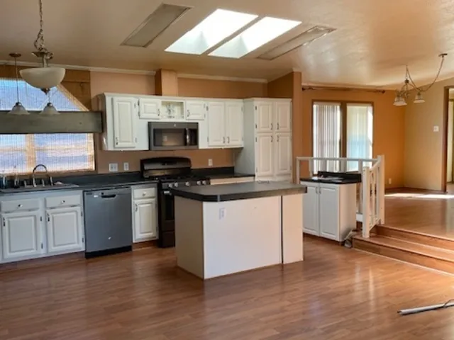 a kitchen with granite countertop a stove and a sink