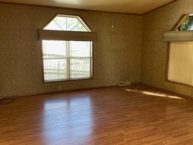 895 Cherry Street Manteno, IL 60950 - Photo 6 of 38 an empty room with wooden floor and windows