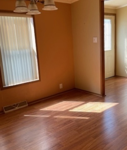 895 Cherry Street Manteno, IL 60950 - Photo 10 of 38 a view of an empty room with wooden floor and a window