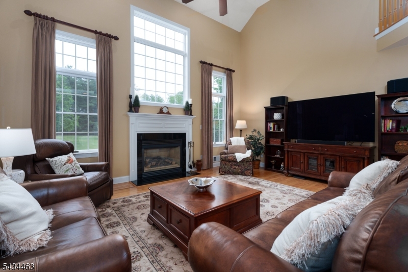 110 Orchard Road Skillman, NJ 08558 - Photo 16 of 43 a living room with furniture a flat screen tv and a large window