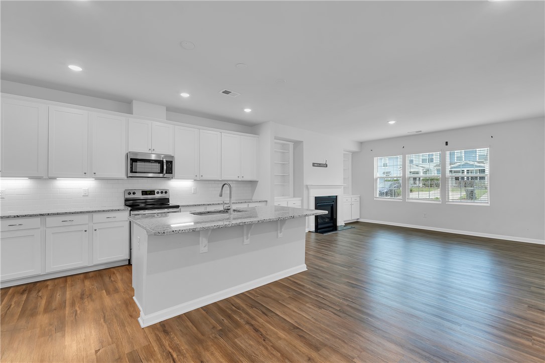 8 Leander Drive Greer, SC 29651 - Photo 21 of 31 A well-lit, open-concept area featuring a modern kitchen and inviting living space.