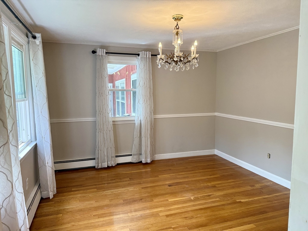 12 Clewes Road Millis, MA 02054 - Photo 3 of 14 a view of a room with wooden floor and chandelier