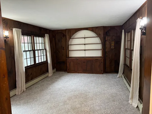 an empty room with windows and closet