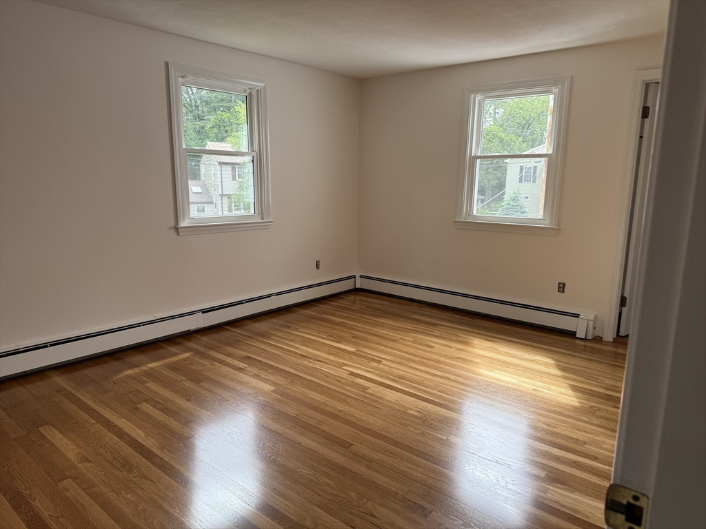 12 Clewes Road Millis, MA 02054 - Photo 6 of 14 a view of empty room with wooden floor and fan