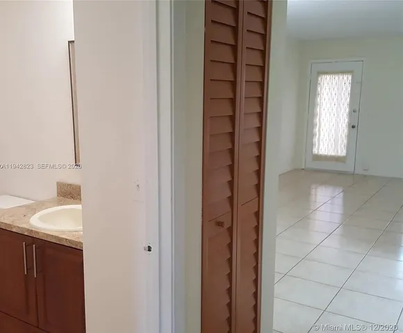 a bathroom with a granite countertop toilet and sink