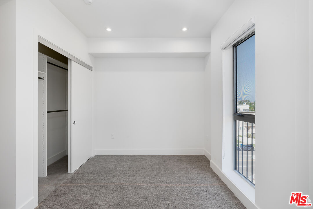 2600 South Sepulveda Boulevard, Unit 405 Los Angeles, CA 90064 - Photo 26 of 33 an empty room with windows