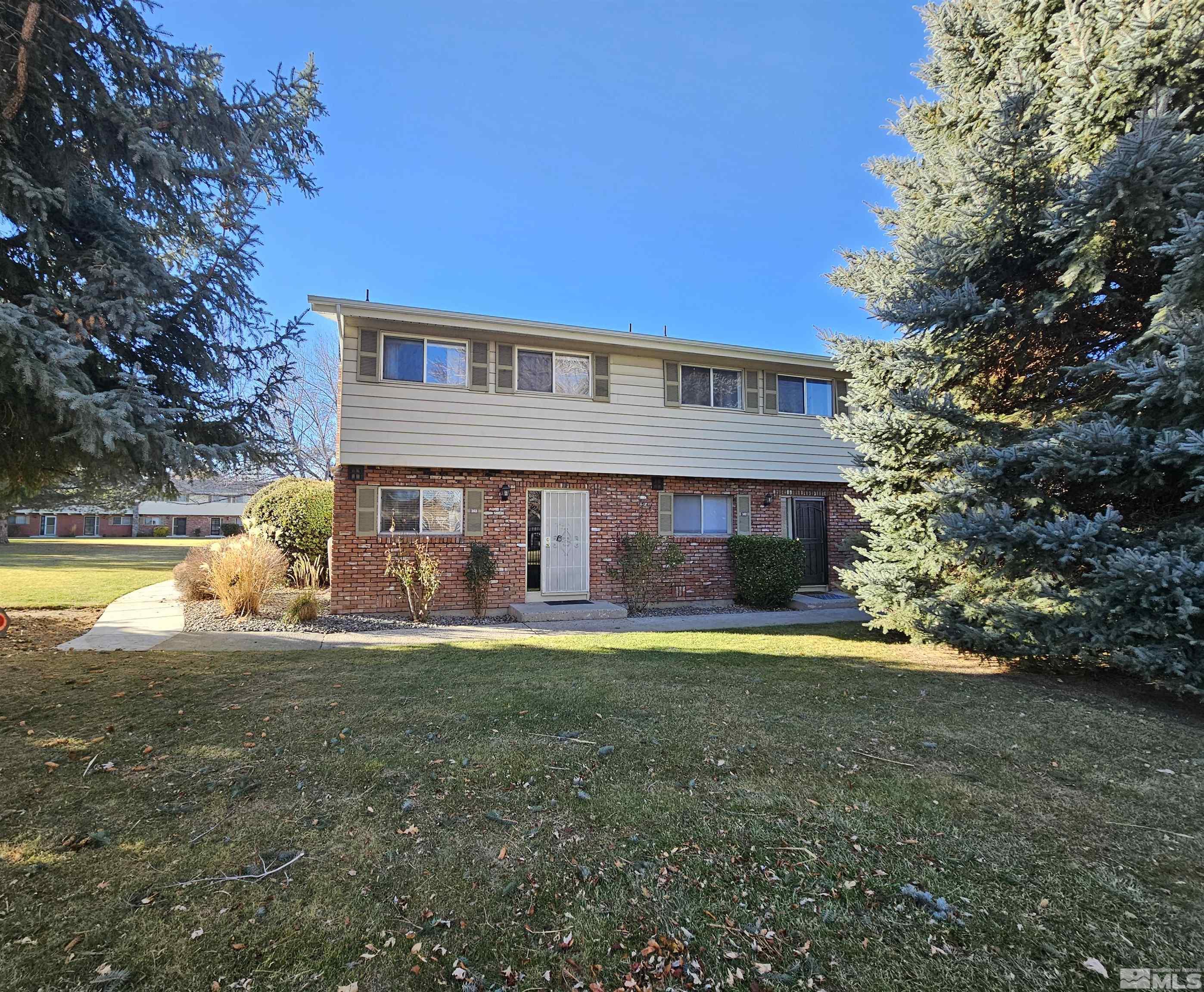 163 Smithridge Park Reno, NV 89502 - Photo 1 of 28 a view of a house with a big yard and large trees