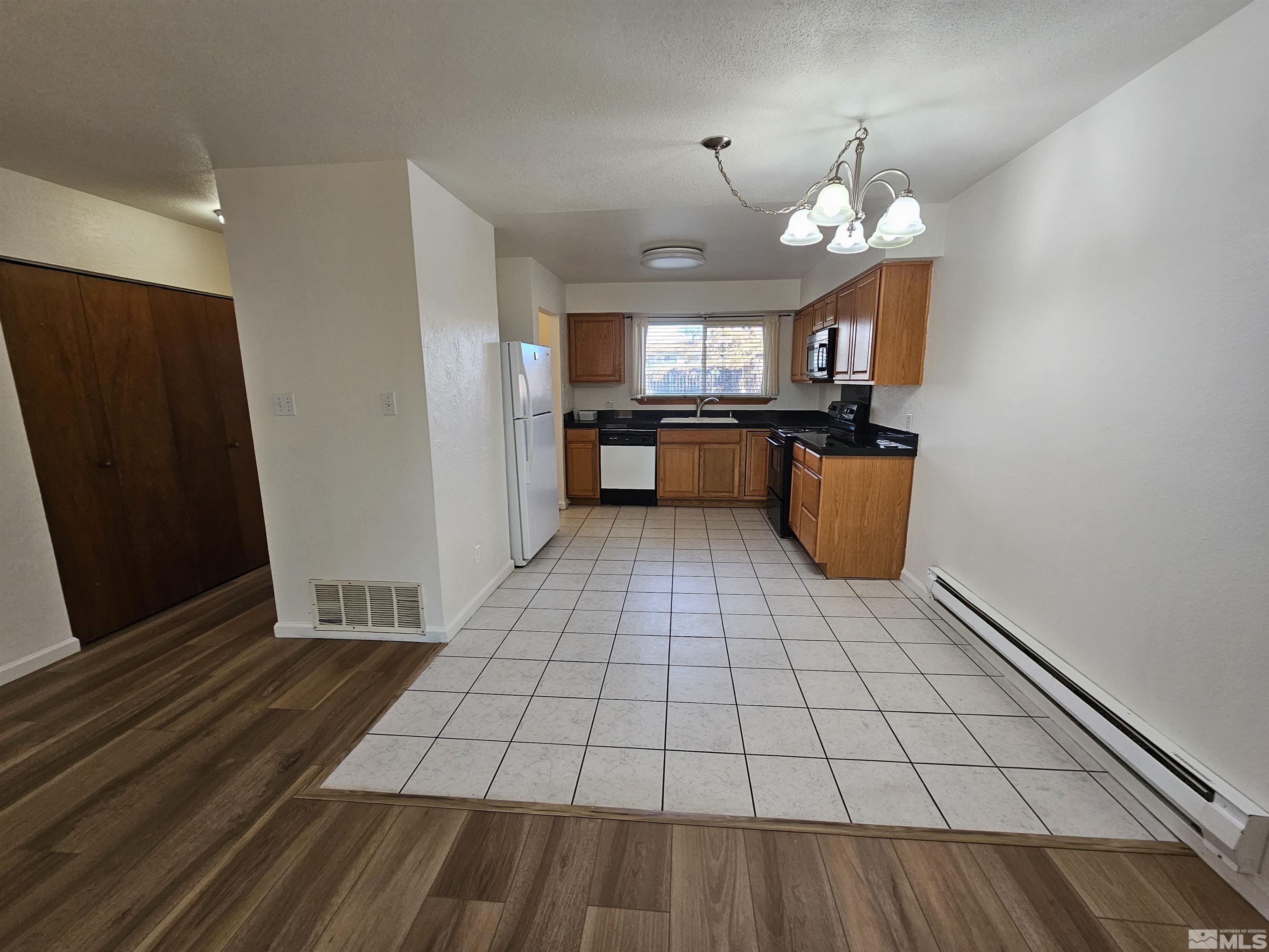 163 Smithridge Park Reno, NV 89502 - Photo 12 of 28 a view of a room with wooden floor and a ceiling fan
