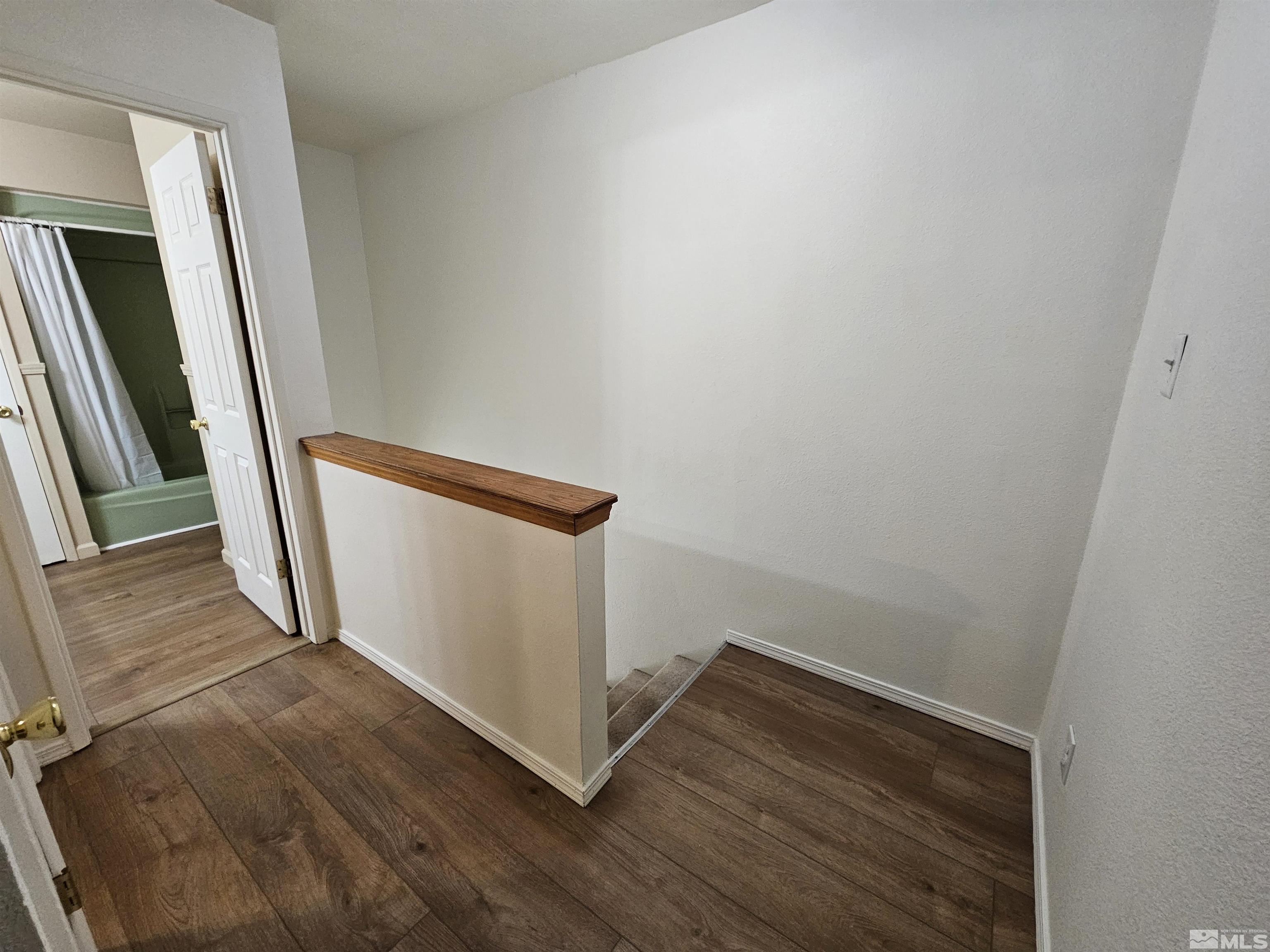163 Smithridge Park Reno, NV 89502 - Photo 13 of 28 an empty room with wooden floor