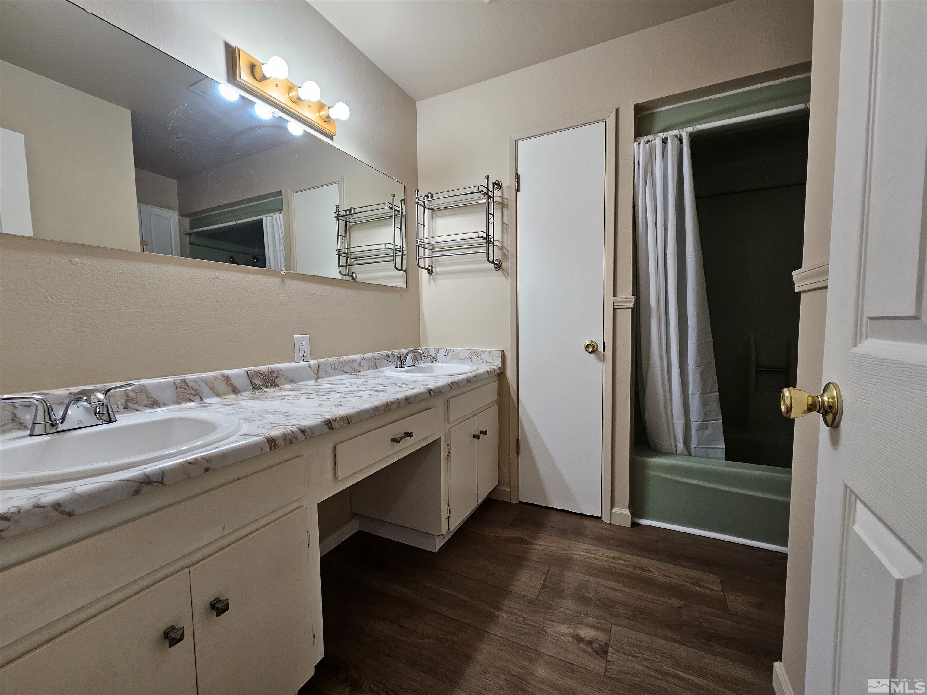 163 Smithridge Park Reno, NV 89502 - Photo 15 of 28 a spacious bathroom with a granite countertop sink and a mirror