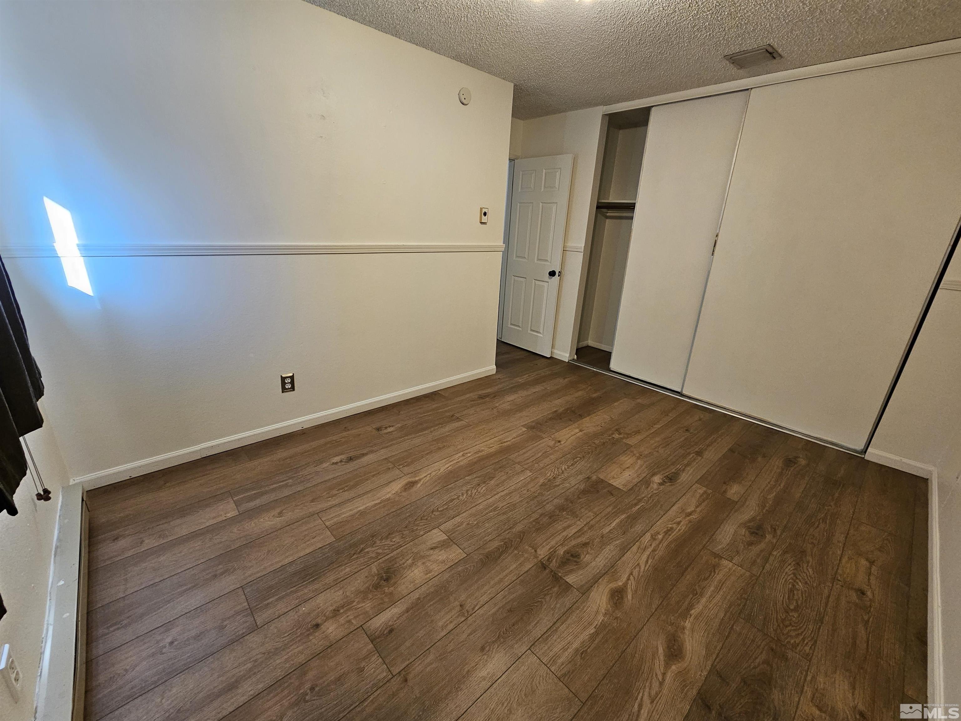 163 Smithridge Park Reno, NV 89502 - Photo 17 of 28 a view of a room with wooden floor