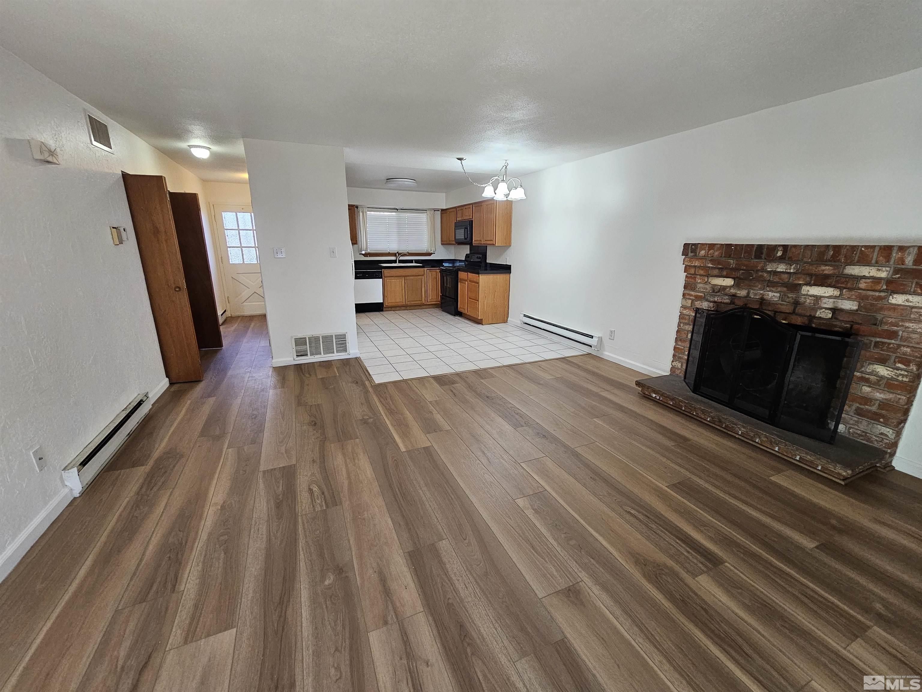 163 Smithridge Park Reno, NV 89502 - Photo 2 of 28 a view of empty room with wooden floor and fireplace