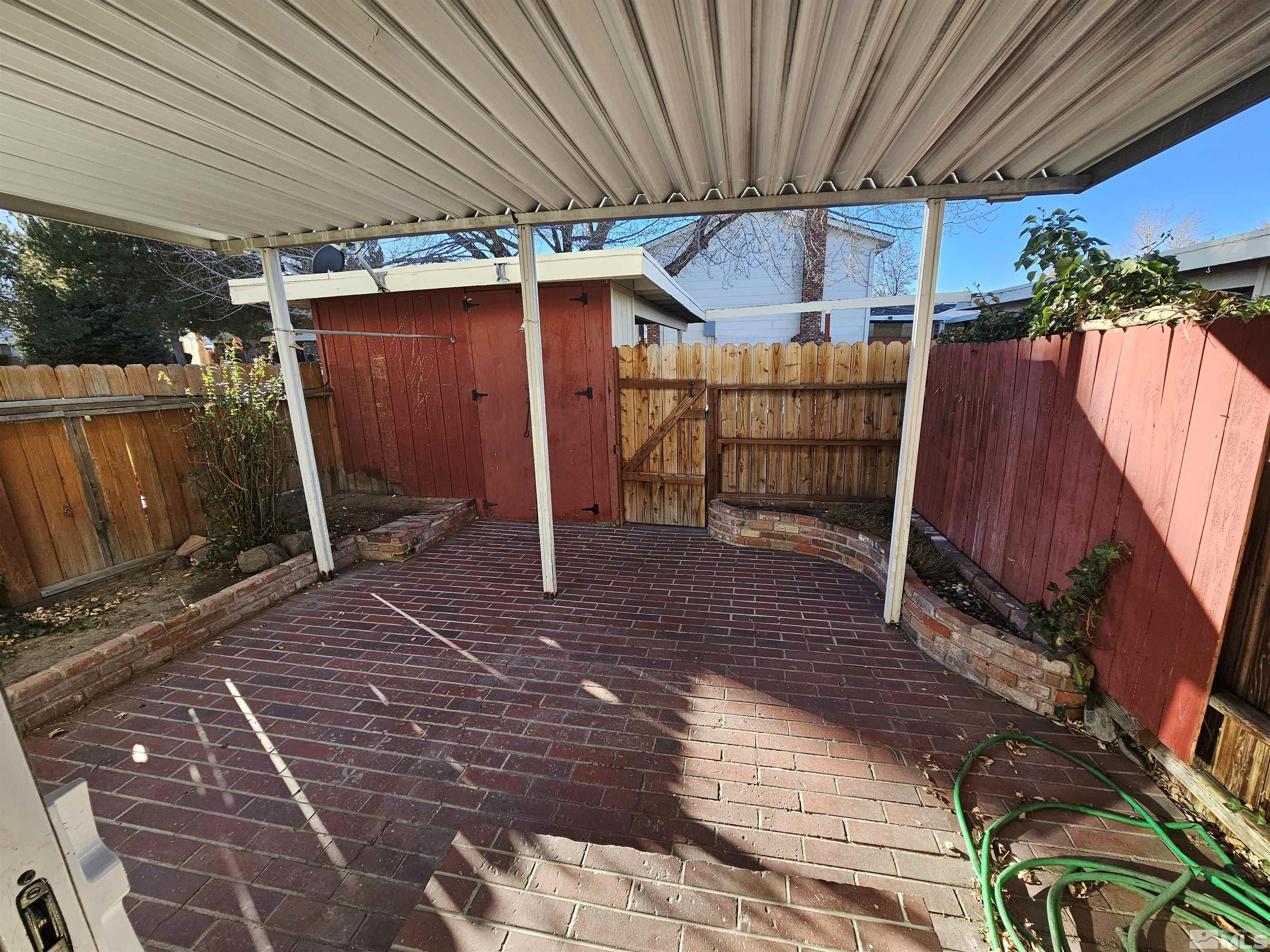 163 Smithridge Park Reno, NV 89502 - Photo 23 of 28 a view of a backyard with table and chairs under an umbrella