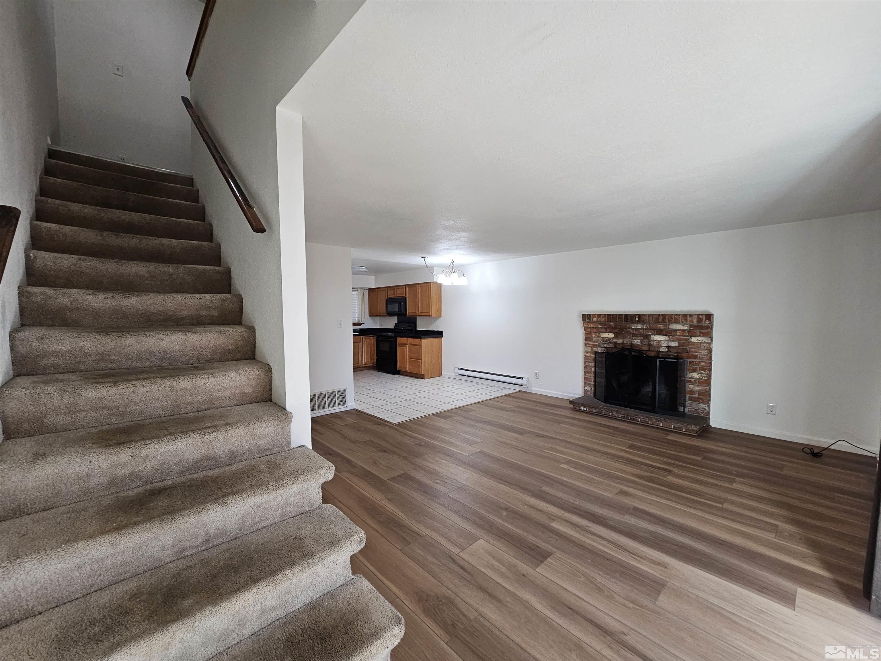 163 Smithridge Park Reno, NV 89502 - Photo 3 of 28 a view of empty room with wooden floor and a fireplace